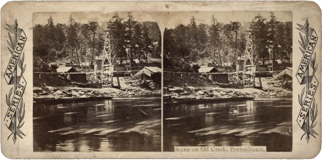 Stereoscopic image of Oil Creek, Pennsylvania, circa 1863–1870, featuring oil derricks, buildings, and the surrounding forested area.