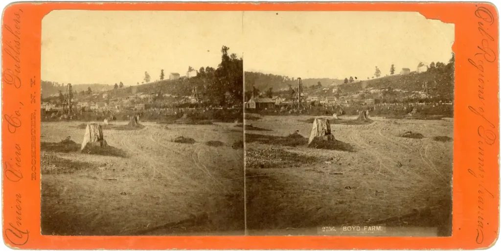 Historic stereograph image of Boyd Farm on Oil Creek, Venango County, PA, showing scattered oil derricks and buildings across a partially cleared, hilly landscape.